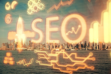 SEO hologram on city view with skyscrapers background double exposure. Search optimization concept.