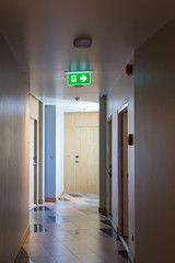 Green emergency exit sign showing the way to escape.Fire exit in the building.