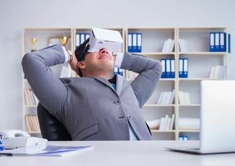 Businessman with virtual reality glasses in modern technology co