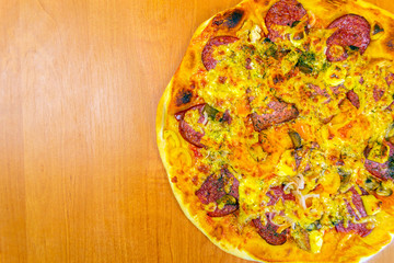 Pizza dough with tomato sauce on a rustic table
