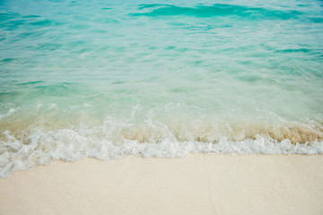 Fototapeta na wymiar Blue sea ocean, water sun reflection, and sand background.