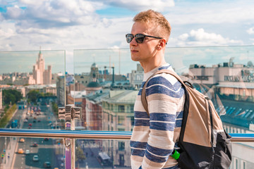 A young man on the roof with a panorama of Moscow, Russia