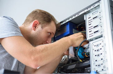 A man fixing a computer. Closeup