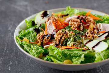 Salad with greens apple chicken and walnuts