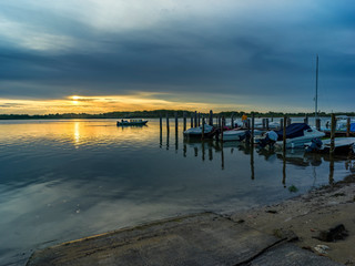 Fototapeta premium Lagoon landscape at dawn with fishermen boats