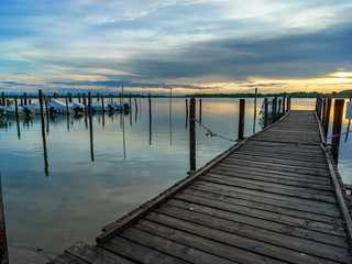 Lagoon landscape at dawn with wooden jetty