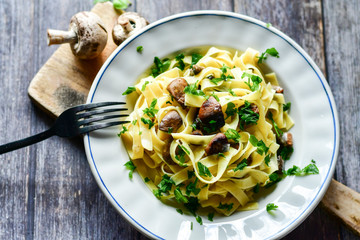 Italian food . Fresh home made  tagliatelle vegetarian  egg pasta  with mushrooms ,parmesan cheese...