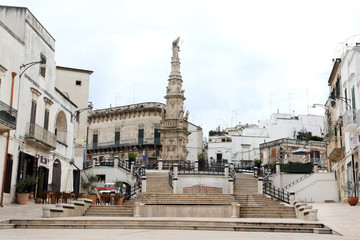Fototapeta na wymiar Ostuni, Italy - October 6, 2010: View of the square with the Column of Sant'Oronzo