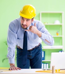 Young male architect working at the project
