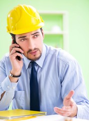 Young male architect working at the project