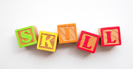 Skill word made from colourful wooden baby development blocks