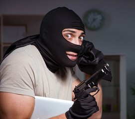 Burglar wearing balaclava mask at crime scene