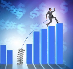 Business people jumping over bar charts