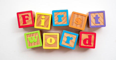 First word word made from colourful wooden baby development blocks