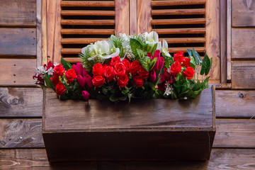 Fototapeta na wymiar red roses bouquet in wooden box
