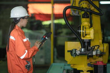 woman working engineering or technical inspection the system  of machinery by online mobile device connecting to ensure working in order by checklist part and quality control