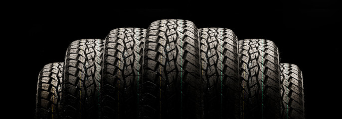 tires on a black background in a row, panoramic photo