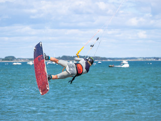 a kitesurfer in full jump