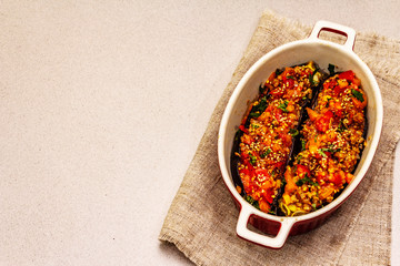 Karniyarik traditional Turkish food from stuffed eggplants with minced meat, tomato, greens and sesame seeds