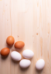 chicken raw eggs on the rustic wooden surface