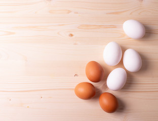 chicken raw eggs on the rustic wooden surface