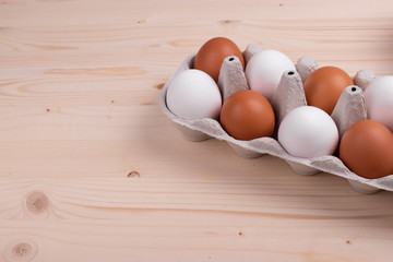 chicken raw eggs on the rustic wooden surface