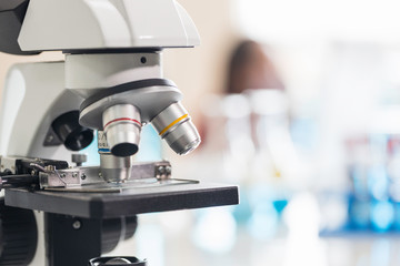 Close-up microscope with metal lens at laboratory.