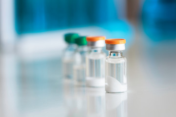 Bottle of vaccine and midicine on the table. Development and creation of a coronavirus vaccine COVID-19.