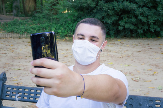 Closeup shot of a male taking a selfie wearing a sanitary mask - concept of the new normal