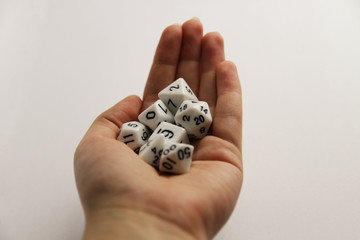 Hand holding the set of 7 white dice