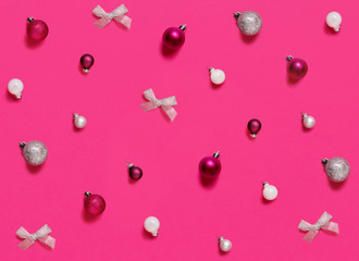 Naklejka premium Christmas decorations and baubles on a pink background