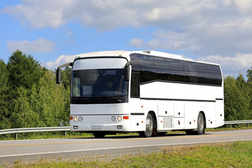Fototapeta na wymiar White Bus on Summer Highway.