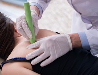 Patient in clinic undergoing laser scar removal