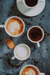 Fresh cappuccino, espresso and turkish coffee mugs. Six coffee mugs shot from above.
