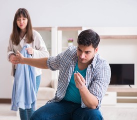 Fototapeta premium Woman evicting man from house during family conflict