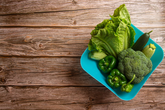 Green Vegetables Viewed From Above On Wooden Background.