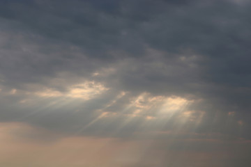 sunrays shine through the clouds