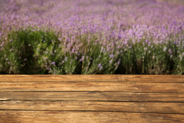 Empty wooden table in fresh lavender field