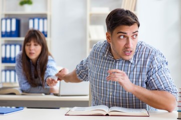 Students sitting and studying in classroom college