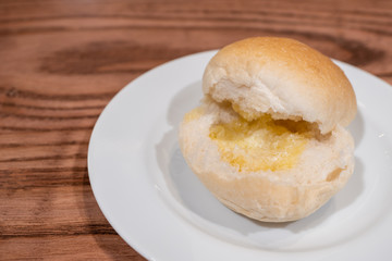 Bun Bread and Butter on wooden table.