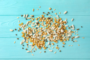 Mixed vegetable seeds on light blue wooden background, flat lay