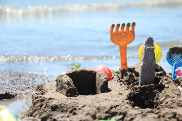 Plastic toys are placed on the shore of a troubled lake