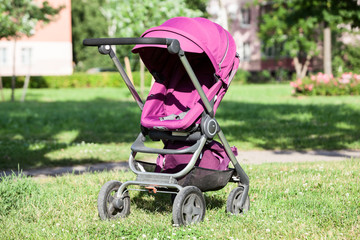 Children pram for baby carriage, compact and collapsable, standing in park, infant perambulator...