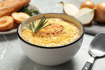 Tasty homemade french onion soup served on grey marble table