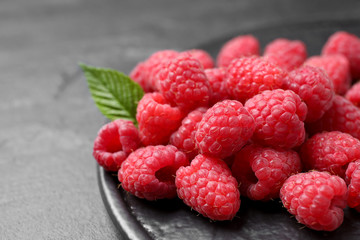 Delicious fresh ripe raspberries on black table, closeup