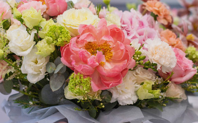 Bouquet in box. Gift box with beautiful flower. Woman holding big beautiful blossoming box bouquet of fresh roses, carnation, peonies, eustoma and others.