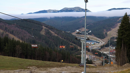 Ukraine, Bukovel - November 20, 2019. Autumn view of the ski resort with a chairlift against the...