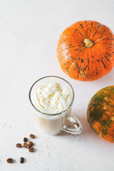 Glass of pumpkin lattee coffee on white background