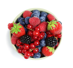 Mix of berries in bowl isolated on white, top view