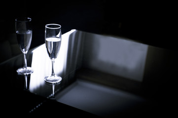 Two glasses of water on a glass table